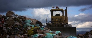 Movie still from “Jonathan Livingston Seagull” (1973), directed by Hall Bartlett – A large pile of trash next to a truck; Extreme Wide shot, Low angle