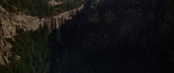 Movie still from “Jonathan Livingston Seagull” (1973), directed by Hall Bartlett – A view of a waterfall in the dark; Extreme Wide shot, High angle