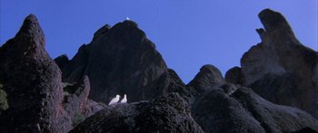 Movie still from “Jonathan Livingston Seagull” (1973), directed by Hall Bartlett – Two birds sitting on top of a rock formation; Extreme Wide shot, Low angle