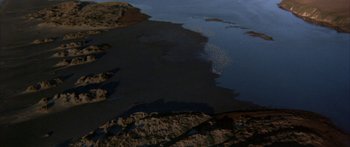 Movie still from “Jonathan Livingston Seagull” (1973), directed by Hall Bartlett – A body of water that has a lot of water on it; Extreme Wide shot, High angle