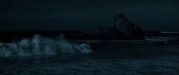 Movie still from “Jonathan Livingston Seagull” (1973), directed by Hall Bartlett – A body of water near a body of water at night time; Extreme Wide shot, Low angle