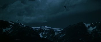 Movie still from “Jonathan Livingston Seagull” (1973), directed by Hall Bartlett – A bird flying in the sky over a mountain range; Extreme Wide shot, Low angle