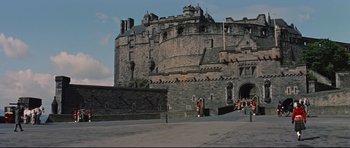 Movie still from “Journey to the Center of the Earth” (1959), directed by Henry Levin – People are standing outside of an old stone castle; Extreme Wide shot, High angle