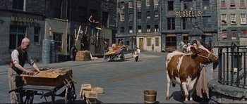 Movie still from “Journey to the Center of the Earth” (1959), directed by Henry Levin – A cow is standing in the middle of the street; Extreme Wide shot, High angle