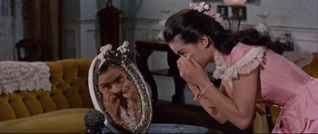 Movie still from “Journey to the Center of the Earth” (1959), directed by Henry Levin – A woman is looking at her reflection in a mirror; Close Up shot, Over the shoulder angle