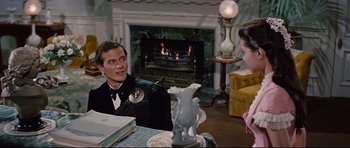 Movie still from “Journey to the Center of the Earth” (1959), directed by Henry Levin – A man and a woman sitting in front of a fireplace; Medium shot, Over the shoulder angle