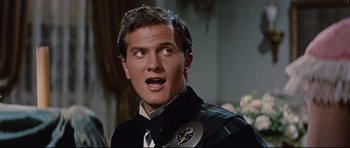 Movie still from “Journey to the Center of the Earth” (1959), directed by Henry Levin – A person wearing a suit and tie; Close Up shot, Over the shoulder angle