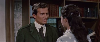 Movie still from “Journey to the Center of the Earth” (1959), directed by Henry Levin – A man and a woman are talking in front of a bookcase; Close Up shot, Over the shoulder angle