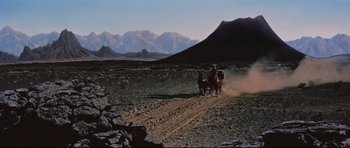 Movie still from “Journey to the Center of the Earth” (1959), directed by Henry Levin – Two men on horses in the middle of the desert; Extreme Wide shot, High angle