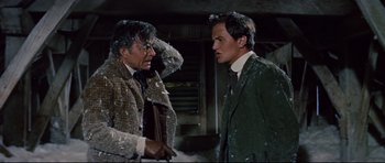 Movie still from “Journey to the Center of the Earth” (1959), directed by Henry Levin – A man and a man in a green jacket; Medium shot, Over the shoulder angle