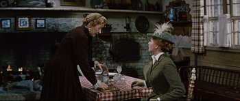 Movie still from “Journey to the Center of the Earth” (1959), directed by Henry Levin – Two women are sitting at a table in a kitchen; Medium shot, Over the shoulder angle