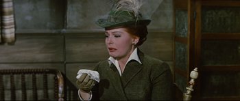 Movie still from “Journey to the Center of the Earth” (1959), directed by Henry Levin – A woman in a green hat holding a piece of paper; Close Up shot, Low angle