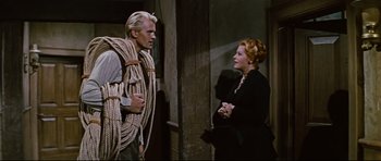 Movie still from “Journey to the Center of the Earth” (1959), directed by Henry Levin – A man and a woman standing next to each other; Medium shot, Over the shoulder angle