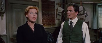 Movie still from “Journey to the Center of the Earth” (1959), directed by Henry Levin – A man and a woman standing next to each other in a room; Medium shot, Over the shoulder angle