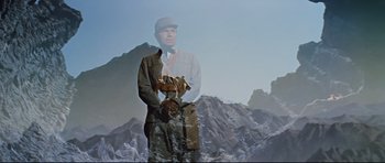 Movie still from “Journey to the Center of the Earth” (1959), directed by Henry Levin – A man standing in front of a mountain; Medium shot, Low angle