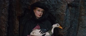 Movie still from “Journey to the Center of the Earth” (1959), directed by Henry Levin – A woman dressed as a witch holding a goose; Medium shot, Low angle