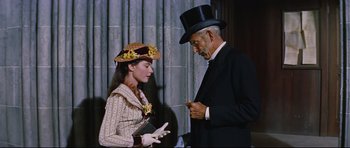 Movie still from “Journey to the Center of the Earth” (1959), directed by Henry Levin – An older man and a young woman wearing hats; Medium shot, Low angle