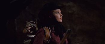 Movie still from “Journey to the Center of the Earth” (1959), directed by Henry Levin – A woman in a black hat holding a rifle; Close Up shot, Low angle
