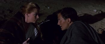 Movie still from “Journey to the Center of the Earth” (1959), directed by Henry Levin – A man and a woman sitting next to each other in the dark; Close Up shot, High angle
