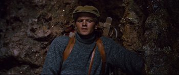 Movie still from “Journey to the Center of the Earth” (1959), directed by Henry Levin – A man wearing a sweater and a hat; Medium shot, Low angle