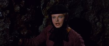 Movie still from “Journey to the Center of the Earth” (1959), directed by Henry Levin – A woman in a black hat and a black scarf; Close Up shot, Low angle