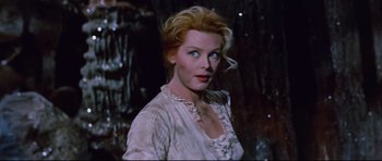 Movie still from “Journey to the Center of the Earth” (1959), directed by Henry Levin – A woman with blonde hair wearing a white dress; Close Up shot, High angle