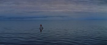 Movie still from “Journey to the Center of the Earth” (1959), directed by Henry Levin – A boat floating on top of a body of water; Extreme Wide shot, High angle