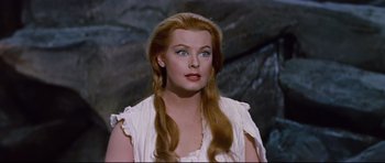 Movie still from “Journey to the Center of the Earth” (1959), directed by Henry Levin – A woman with long red hair wearing a white dress; Close Up shot, High angle