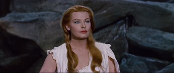Movie still from “Journey to the Center of the Earth” (1959), directed by Henry Levin – A woman with long red hair wearing a white dress; Close Up shot, Low angle