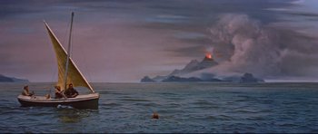 Movie still from “Journey to the Center of the Earth” (1959), directed by Henry Levin – A body of water that has a boat in the water; Extreme Wide shot, High angle