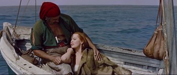 Movie still from “Journey to the Center of the Earth” (1959), directed by Henry Levin – A man and a woman sitting in a boat on the water; Medium shot, High angle