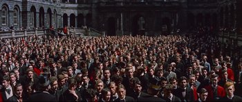 Movie still from “Journey to the Center of the Earth” (1959), directed by Henry Levin – A large group of men in suits and ties; Extreme Wide shot, High angle
