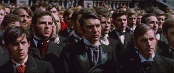 Movie still from “Journey to the Center of the Earth” (1959), directed by Henry Levin – A group of men in suits and ties standing in a crowd; Close Up shot, High angle