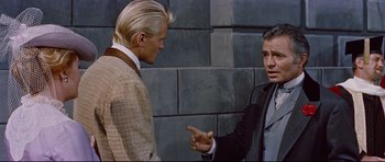 Movie still from “Journey to the Center of the Earth” (1959), directed by Henry Levin – A man in a suit talking to another man in a suit and tie; Medium shot, Over the shoulder angle
