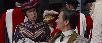 Movie still from “Journey to the Center of the Earth” (1959), directed by Henry Levin – A group of people standing next to each other in a room; Close Up shot, Over the shoulder angle