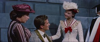 Movie still from “Journey to the Center of the Earth” (1959), directed by Henry Levin – A man and two women wearing hats and suits; Medium shot, Over the shoulder angle