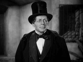 Movie still from “Juarez” (1939), directed by William Dieterle – A man wearing a top hat and a black suit; Close Up shot, Low angle