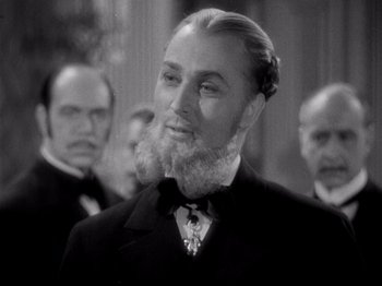 Movie still from “Juarez” (1939), directed by William Dieterle – A man with a long beard is in front of a group of men; Close Up shot, Low angle