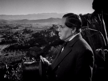 Movie still from “Juarez” (1939), directed by William Dieterle – A black and white photo of a man looking out over a valley; Medium shot, Low angle