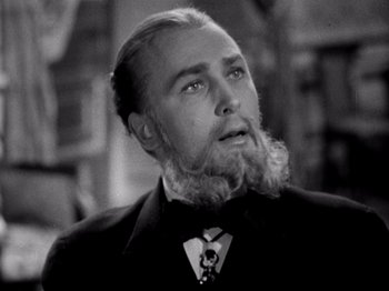 Movie still from “Juarez” (1939), directed by William Dieterle – A man with a long beard is wearing a suit and tie; Close Up shot, Low angle
