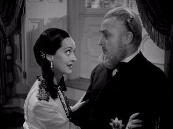 Movie still from “Juarez” (1939), directed by William Dieterle – A man and a woman standing next to each other; Close Up shot, High angle