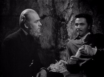 Movie still from “Juarez” (1939), directed by William Dieterle – A man with a beard is talking to another man; Medium shot, Low angle