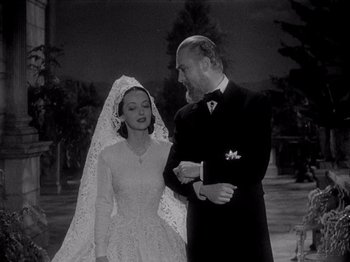 Movie still from “Juarez” (1939), directed by William Dieterle – An old photo of a man and a woman; Medium shot, Low angle