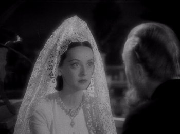 Movie still from “Juarez” (1939), directed by William Dieterle – A black and white photo of a woman wearing a wedding veil; Close Up shot, Over the shoulder angle