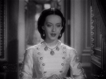 Movie still from “Juarez” (1939), directed by William Dieterle – A black - and - white photo of a woman in a white dress; Close Up shot, High angle