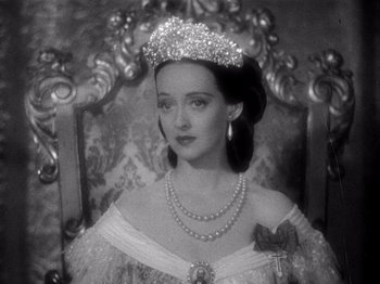 Movie still from “Juarez” (1939), directed by William Dieterle – A black and white photo of a woman wearing a tiara; Close Up shot, High angle