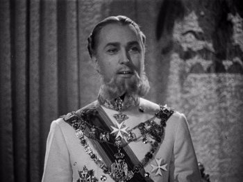 Movie still from “Juarez” (1939), directed by William Dieterle – A man with a long beard wearing a suit; Close Up shot, High angle