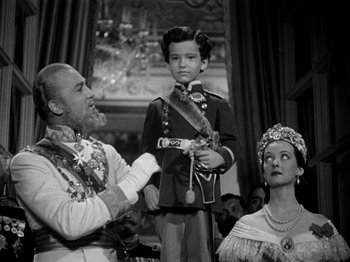 Movie still from “Juarez” (1939), directed by William Dieterle – A man and a woman and a boy in a costume; Medium shot, Low angle