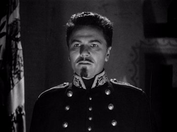 Movie still from “Juarez” (1939), directed by William Dieterle – A black and white photo of a man in a military uniform; Close Up shot, Low angle