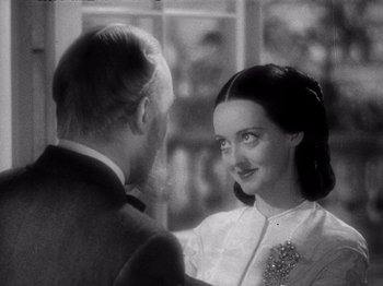 Movie still from “Juarez” (1939), directed by William Dieterle – A man and a woman standing next to each other in front of a window; Close Up shot, Over the shoulder angle